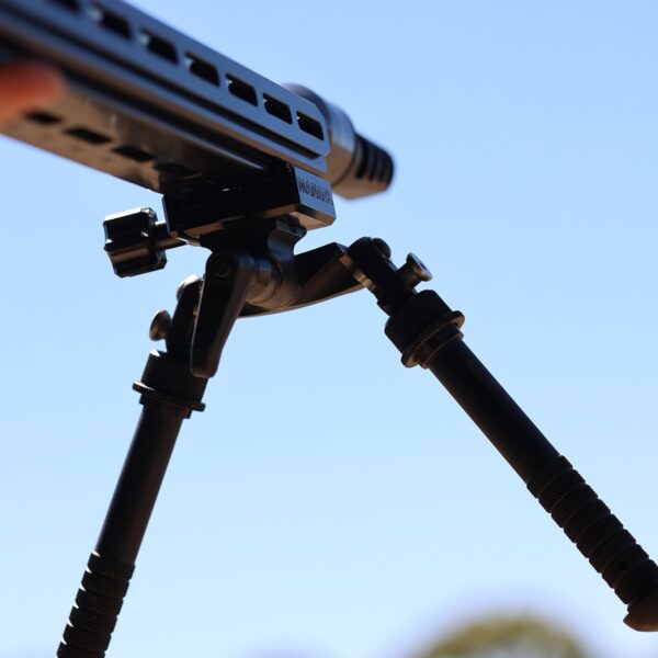 MANAEL Chassis Arca Swiss High-quality Australian-made rifle shooting gear on a tripod against a blue sky.