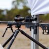 MANAEL Sedajo Chassis with Enclosed Foreend Rail Covers Precision rifle with scope on tripod for Australian-made shooting gear.