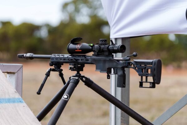 MANAEL Sedajo Chassis with Enclosed Foreend Rail Covers Precision rifle with scope on tripod for Australian-made shooting gear.
