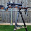 MANAEL Ultralite Hunter Arca Swiss Rail-Tikka Rifle with scope on a tripod, Australian-made shooting gear, outdoor setup, custom camouflage design.