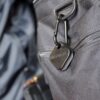 MANAEL Arca Swiss Coin Aussie made rifle shooting gear on grey tactical bag with MANAEL branded keychain.
