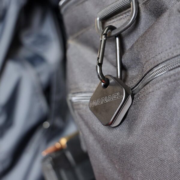 MANAEL Arca Swiss Coin Aussie made rifle shooting gear on grey tactical bag with MANAEL branded keychain.